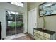 A well-lit foyer with light green walls, tile floors, and access to an outdoor patio at 9642 Meade Ct, Westminster, CO 80031