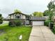 Charming brick and siding home with a well-maintained lawn and a two-car garage at 9642 Meade Ct, Westminster, CO 80031