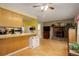 Open-concept living area showcasing a brick fireplace adjacent to the eat-in kitchen at 9642 Meade Ct, Westminster, CO 80031