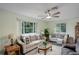 Cozy living room with neutral furniture, large windows, and a ceiling fan at 9642 Meade Ct, Westminster, CO 80031
