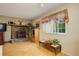 Cozy living room featuring a brick fireplace, wood floors, and a bright window at 9642 Meade Ct, Westminster, CO 80031