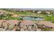 Stunning aerial shot of a home surrounded by lush landscaping, with a serene lake and a golf course in the backdrop at 10061 Bluffmont Ct, Lone Tree, CO 80124