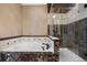 Well-appointed bathroom showcasing a soaking tub and separate glass-enclosed shower with stylish tile work at 10061 Bluffmont Ct, Lone Tree, CO 80124