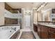 Spacious bathroom with a soaking tub, glass-enclosed shower, and double vanity with marble countertops at 10061 Bluffmont Ct, Lone Tree, CO 80124