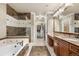 This elegant bathroom features marble accents, a soaking tub, and a glass enclosed shower at 10061 Bluffmont Ct, Lone Tree, CO 80124