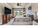 Cozy bedroom showcasing a comfortable bed, a window with outdoor views, and stylish furnishings at 10061 Bluffmont Ct, Lone Tree, CO 80124