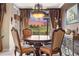 This formal dining area boasts a decorative chandelier and views of the outdoors, ideal for Gathering gatherings and dinner parties at 10061 Bluffmont Ct, Lone Tree, CO 80124