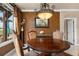 Charming dining area features a classic wooden table, chandelier, and warm, inviting decor at 10061 Bluffmont Ct, Lone Tree, CO 80124