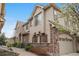 Charming exterior view of a well-maintained home with a tiled roof, stone accents, and attached garage in a beautiful neighborhood at 10061 Bluffmont Ct, Lone Tree, CO 80124