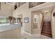 Welcoming foyer with soaring ceilings, a staircase, and view to the living and dining areas at 10061 Bluffmont Ct, Lone Tree, CO 80124