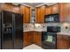 Modern kitchen features dark wood cabinets and granite countertops at 10061 Bluffmont Ct, Lone Tree, CO 80124