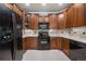 Well-equipped kitchen with wooden cabinets, granite counters, and modern appliances at 10061 Bluffmont Ct, Lone Tree, CO 80124
