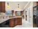 Charming kitchen featuring granite countertops and stainless steel sink overlooking the living room at 10061 Bluffmont Ct, Lone Tree, CO 80124