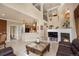 Open floor plan showcasing the living room with fireplace and access to the kitchen at 10061 Bluffmont Ct, Lone Tree, CO 80124