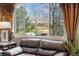 Comfortable living room with leather sofa, a large window with lovely outdoor views at 10061 Bluffmont Ct, Lone Tree, CO 80124