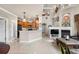 Open-concept area with a cozy fireplace, modern kitchen, and access to the home's entry and other living spaces at 10061 Bluffmont Ct, Lone Tree, CO 80124