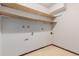The basement has some open shelving above exposed pipes and some tile flooring at 9824 Lane St, Thornton, CO 80260