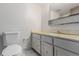 Bathroom features a marble-style floor, a vanity with a bright countertop, and a toilet at 9824 Lane St, Thornton, CO 80260