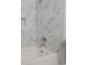 Modern bathroom with tiled walls, bathtub and shower head at 9824 Lane St, Thornton, CO 80260