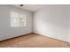 A modest bedroom has neutral carpet, a window providing natural light, and a blank canvas for personalization at 9824 Lane St, Thornton, CO 80260