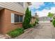 View of brick exterior with white shutters and landscaping at 9824 Lane St, Thornton, CO 80260