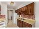 Cozy kitchen with brick backsplash, stainless steel sink, and ample cabinet storage at 9824 Lane St, Thornton, CO 80260