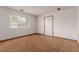 Bright living room with wood-look floors, a large window, and a neutral color palette at 9824 Lane St, Thornton, CO 80260