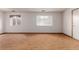 Spacious living room features wood-look floors, large windows, and natural light at 9824 Lane St, Thornton, CO 80260