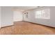 Open living room featuring hardwood floors, plenty of natural light, and neutral paint at 9824 Lane St, Thornton, CO 80260