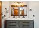A primary bathroom featuring a double vanity with a modern farmhouse design and rustic wood framed mirrors at 10441 Carriage Club Dr, Lone Tree, CO 80124