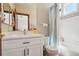 An updated bathroom features a vanity with modern fixtures and a shower and tub combination at 10441 Carriage Club Dr, Lone Tree, CO 80124