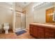 A full bath includes a tiled shower, terracotta tile flooring, and a coordinating vanity at 10441 Carriage Club Dr, Lone Tree, CO 80124