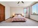 Relaxing bedroom features a cozy bed, bedside lamps, neutral decor, and a large window for natural light at 10441 Carriage Club Dr, Lone Tree, CO 80124