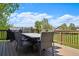 Outdoor dining area on a spacious deck with a grill, table, and seating, ideal for summer gatherings at 10441 Carriage Club Dr, Lone Tree, CO 80124