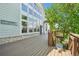 Large deck with wooden floor and walls with large windows and a stone base on the home at 10441 Carriage Club Dr, Lone Tree, CO 80124