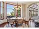 Bright dining nook with large window, cozy seating, and outdoor access at 10441 Carriage Club Dr, Lone Tree, CO 80124