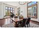 Elegant dining room with a large wooden table, comfortable seating, and lots of windows at 10441 Carriage Club Dr, Lone Tree, CO 80124