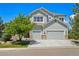 Beautiful two-story home with a three car garage, stone accents, and mature landscaping at 10441 Carriage Club Dr, Lone Tree, CO 80124