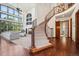 Grand foyer with a curved staircase, hardwood floors, and large windows offering lots of natural light at 10441 Carriage Club Dr, Lone Tree, CO 80124