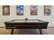 A game room with four posters of popular movies hangs above a large air hockey table at 10441 Carriage Club Dr, Lone Tree, CO 80124