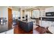 Modern kitchen boasts stainless appliances, granite countertops, gas cooktop, and a large island for meal prep at 10441 Carriage Club Dr, Lone Tree, CO 80124