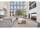 Bright living room featuring soaring windows, plush seating, and stylish decor at 10441 Carriage Club Dr, Lone Tree, CO 80124