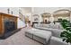 Spacious living room with a fireplace, grand staircase, and comfortable seating at 10441 Carriage Club Dr, Lone Tree, CO 80124