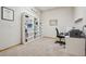A home office with a desk, chair, bookshelves, and neutral colored walls and carpet at 10441 Carriage Club Dr, Lone Tree, CO 80124