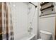 This bathroom showcases subway tile in the shower and a bathtub with an industrial-style shelving unit and toilet at 10441 Carriage Club Dr, Lone Tree, CO 80124