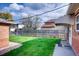 Neat backyard with grassy lawn and brick fence at 2028 Perry St, Denver, CO 80212