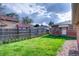 Good-sized backyard with grassy area and brick fence at 2028 Perry St, Denver, CO 80212