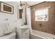 Clean bathroom with tub, shower, and updated vanity at 2028 Perry St, Denver, CO 80212