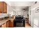 Kitchen with stove and view into the living room at 2028 Perry St, Denver, CO 80212