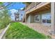 Green backyard showcasing a patio, stairs to a wooden deck, and well-maintained landscaping at 4406 Sidewinder Loop, Castle Rock, CO 80108